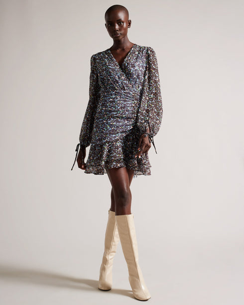 CHERELA-Dresses-It might be downright impossible to not look amazing in CHERELA. With its dropped waist and ruching on the front, pair with a sleek up-do and you're good to go.The fabric of this product is made of 100% recycled polyester. Using recycled polyester helps divert plastic waste from ending in landfills, and helps us to reduce our dependence on virgin materials. Mini dress Long sleeved V-neck Ruched front Ditsy floral print Dropped waist Awuoi is 5'10.5" / 1.79m and wears Light Blue in a Ted size